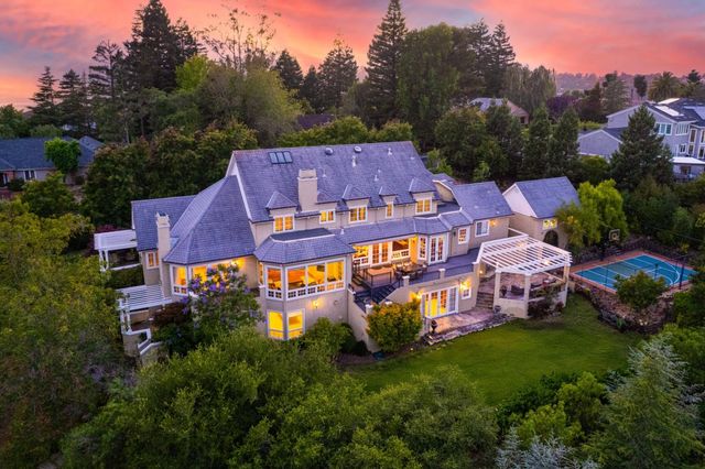 an aerial view of a house with a big yard