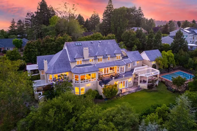 an aerial view of a house with a big yard
