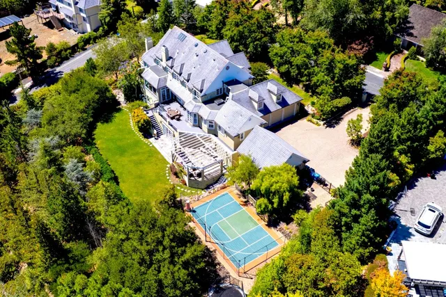 an aerial view of a house with a yard