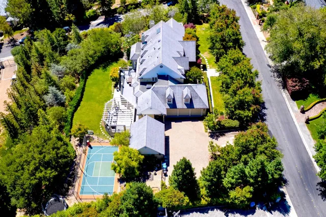 an aerial view of a house with a yard and garden