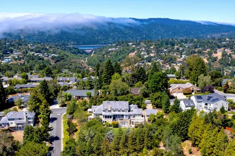 an aerial view of residential house and sandy dunes