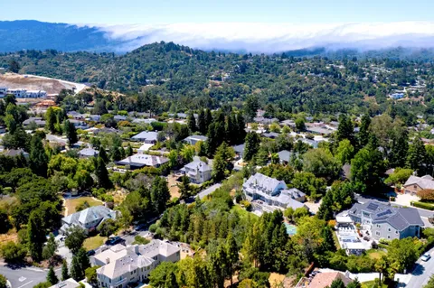 an aerial view of residential houses with outdoor space