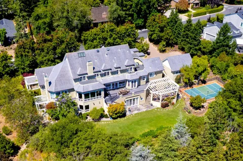 an aerial view of multiple houses with yard
