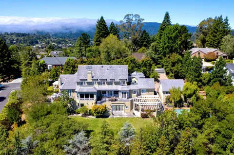 an aerial view of multiple houses with a yard