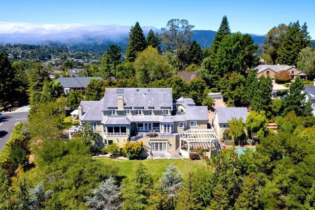 an aerial view of multiple houses with a yard