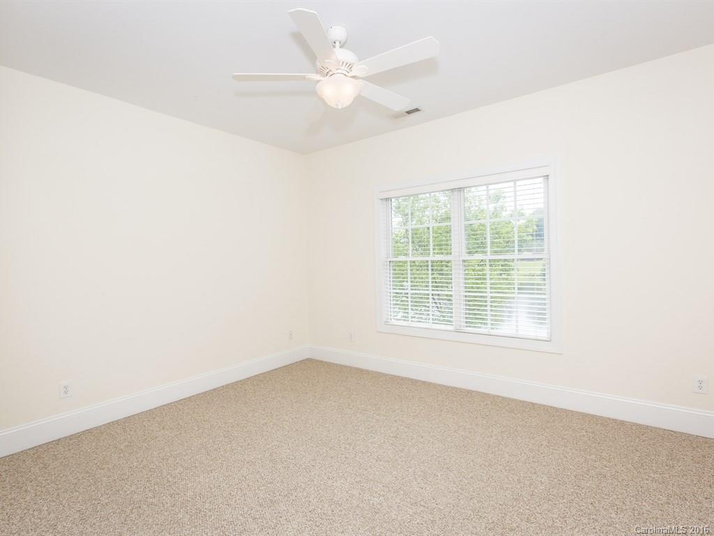 609 Crosswater Lane Fort Mill, SC 29708 - Photo 18 of 24 an empty room with a window and a ceiling fan