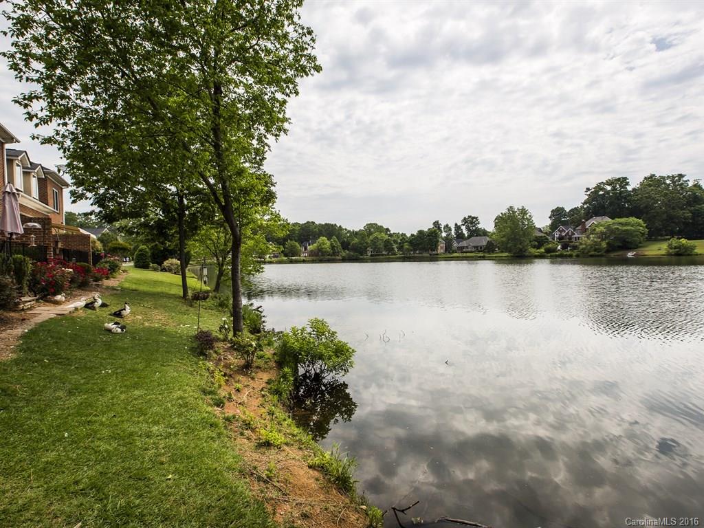 609 Crosswater Lane Fort Mill, SC 29708 - Photo 21 of 24 a view of a lake with houses in the back