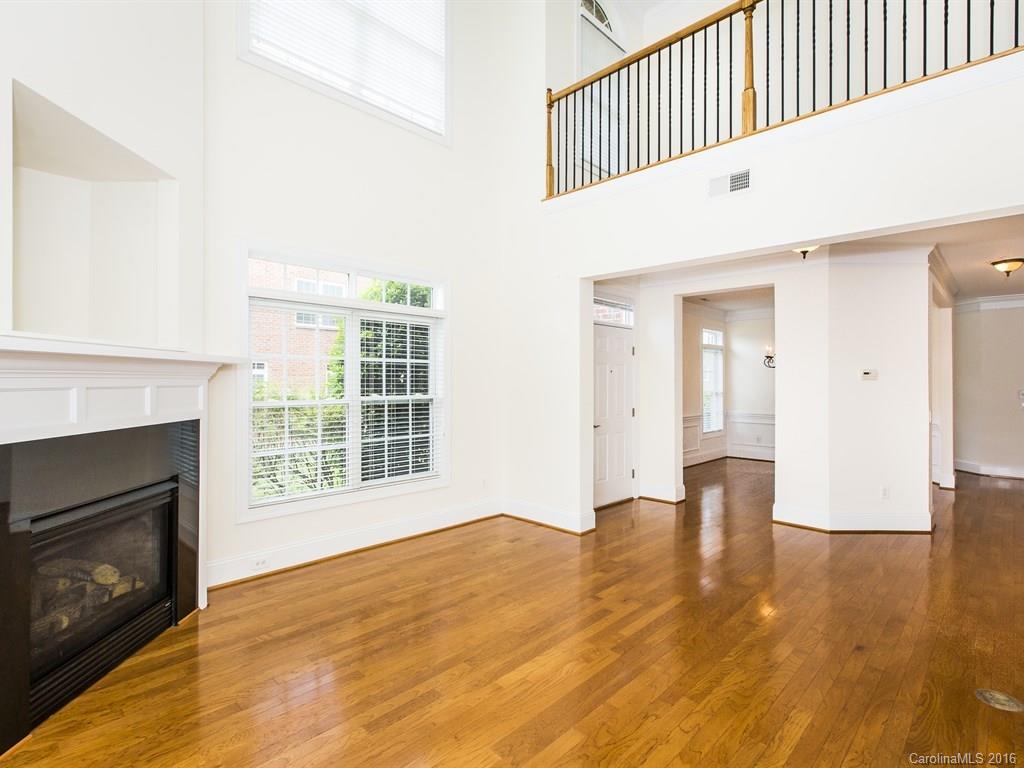 609 Crosswater Lane Fort Mill, SC 29708 - Photo 4 of 24 a view of an empty room with wooden floor fireplace and a window