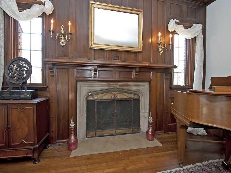 10 Midway Road Mt. Lebanon, PA 15216 - Photo 3 of 16 Living Room. One-of-a-kind appointments. Paneled and pegged wall in living room surrounding limestone fireplace with original fire screen.