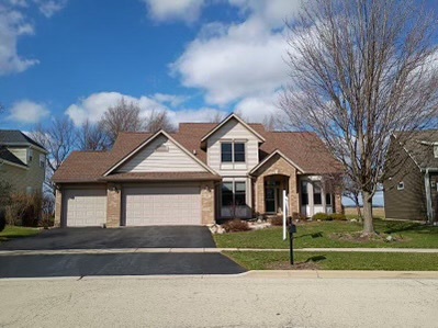 457 Davis Drive Sycamore, IL 60178 - Photo 2 of 32 a front view of a house with a garden