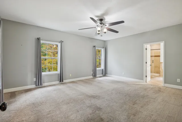 a spacious bathroom with a sink a large mirror and a bathtub
