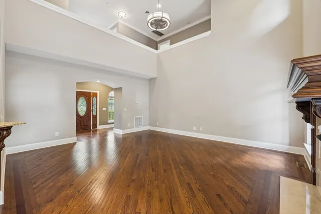 a large kitchen with stainless steel appliances a sink and cabinets
