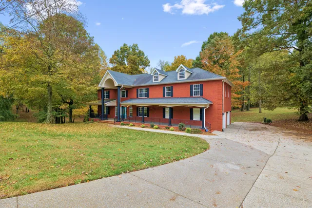 a view of a house with a yard and sitting area