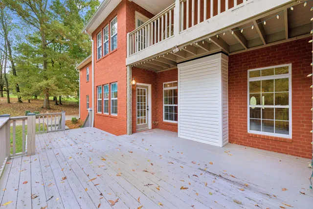 an aerial view of a house with a yard and lake view