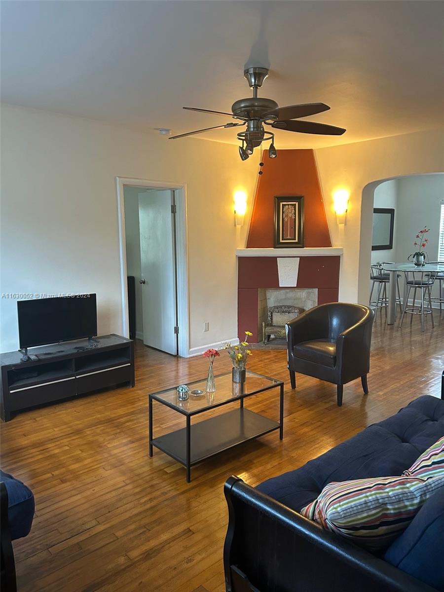 1241 13th Street, Unit 4 Miami Beach, FL 33139 - Photo 1 of 13 a living room with furniture and a flat screen tv