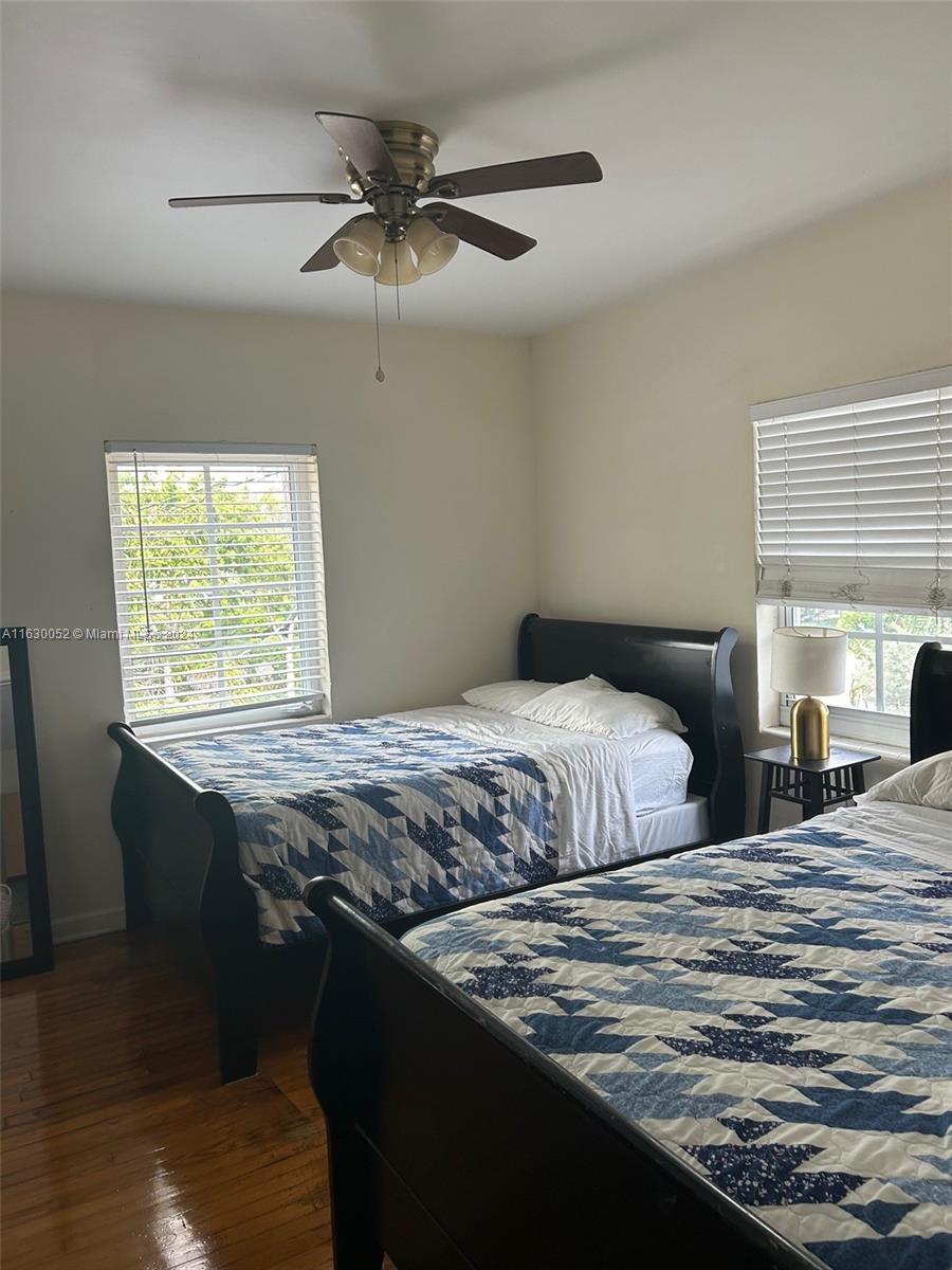 1241 13th Street, Unit 4 Miami Beach, FL 33139 - Photo 11 of 13 a bedroom with a bed and a window