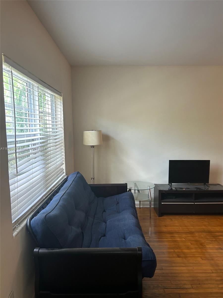 1241 13th Street, Unit 4 Miami Beach, FL 33139 - Photo 4 of 13 a living room with furniture and a flat screen tv