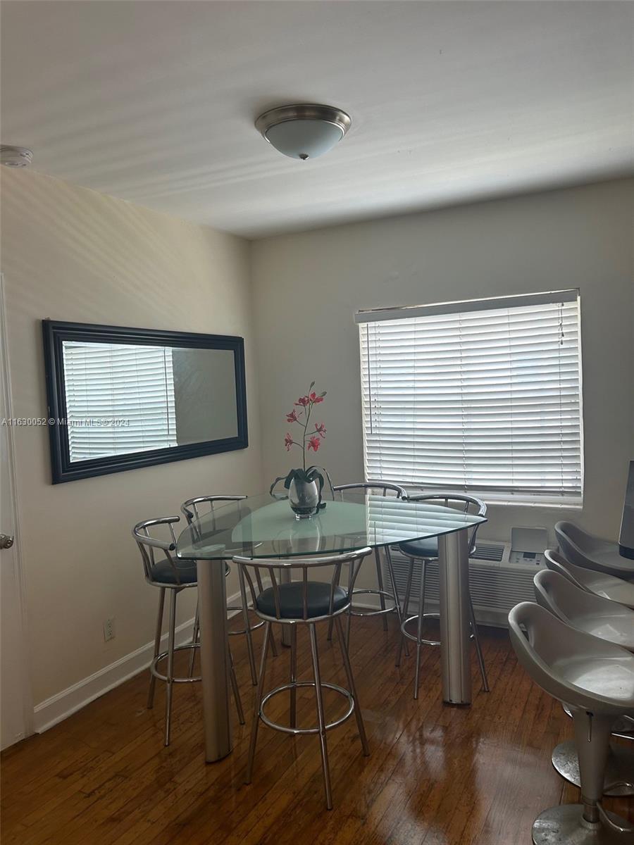 1241 13th Street, Unit 4 Miami Beach, FL 33139 - Photo 5 of 13 a room with table chairs and wooden floor