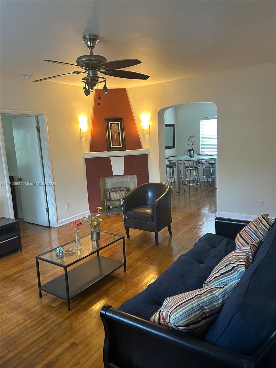 1241 13th Street, Unit 4 Miami Beach, FL 33139 - Photo 10 of 13 a living room with furniture and a wooden floor