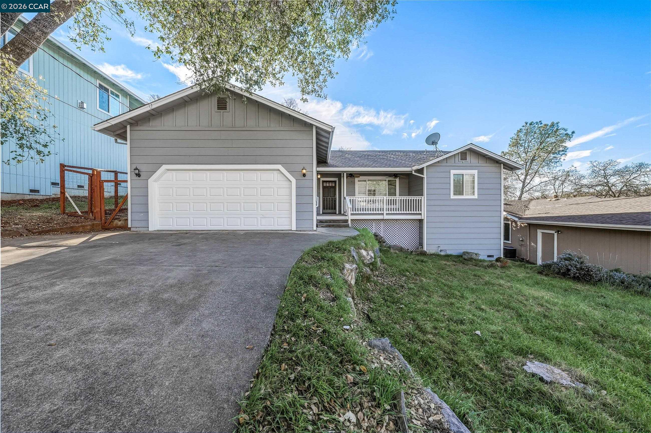 a front view of a house with a yard and garage