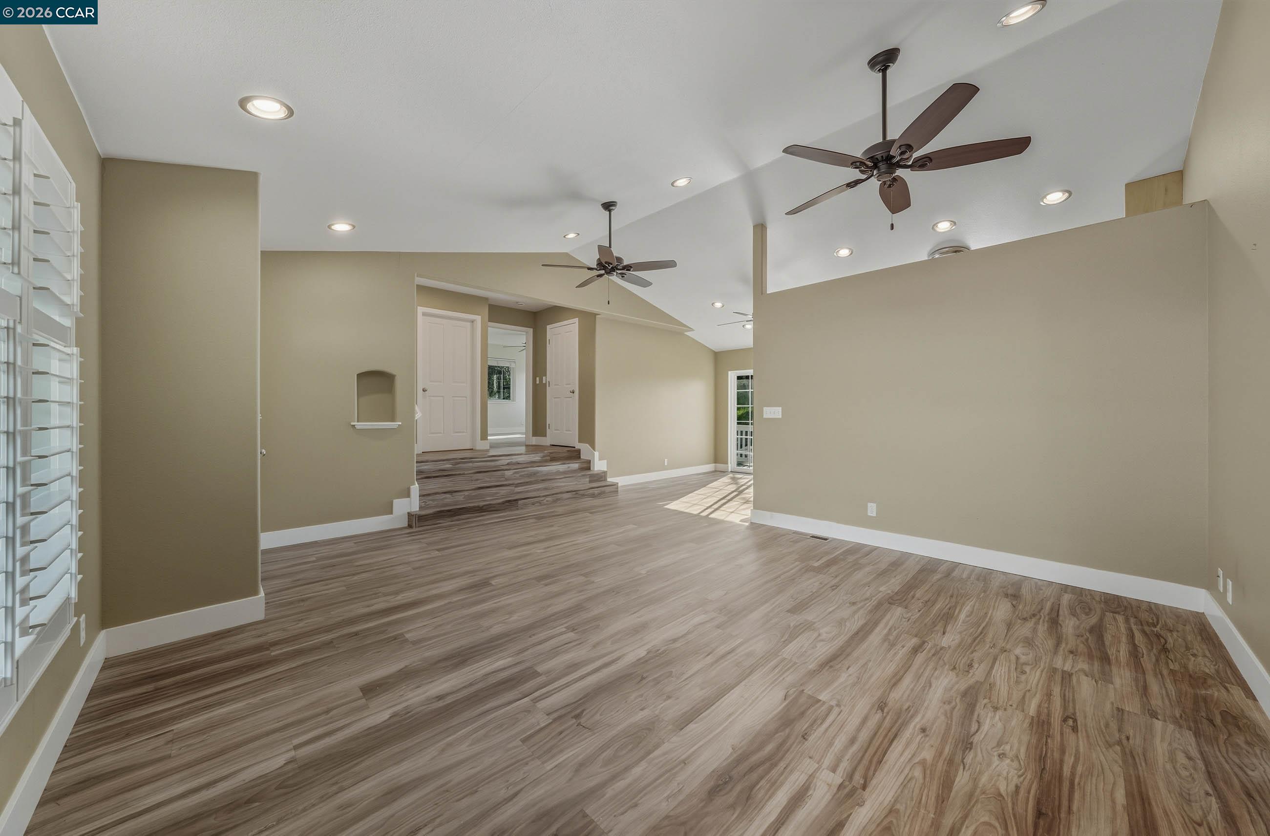 18357 Deer Hill Road Hidden Valley Lake, CA 95467 - Photo 14 of 29 an empty room with wooden floor fan and windows