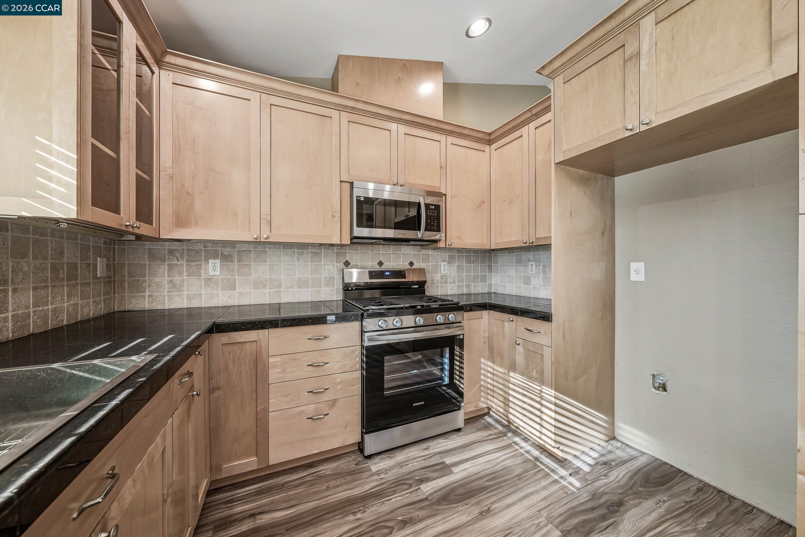 18357 Deer Hill Road Hidden Valley Lake, CA 95467 - Photo 18 of 29 a kitchen with stainless steel appliances granite countertop a stove and a sink