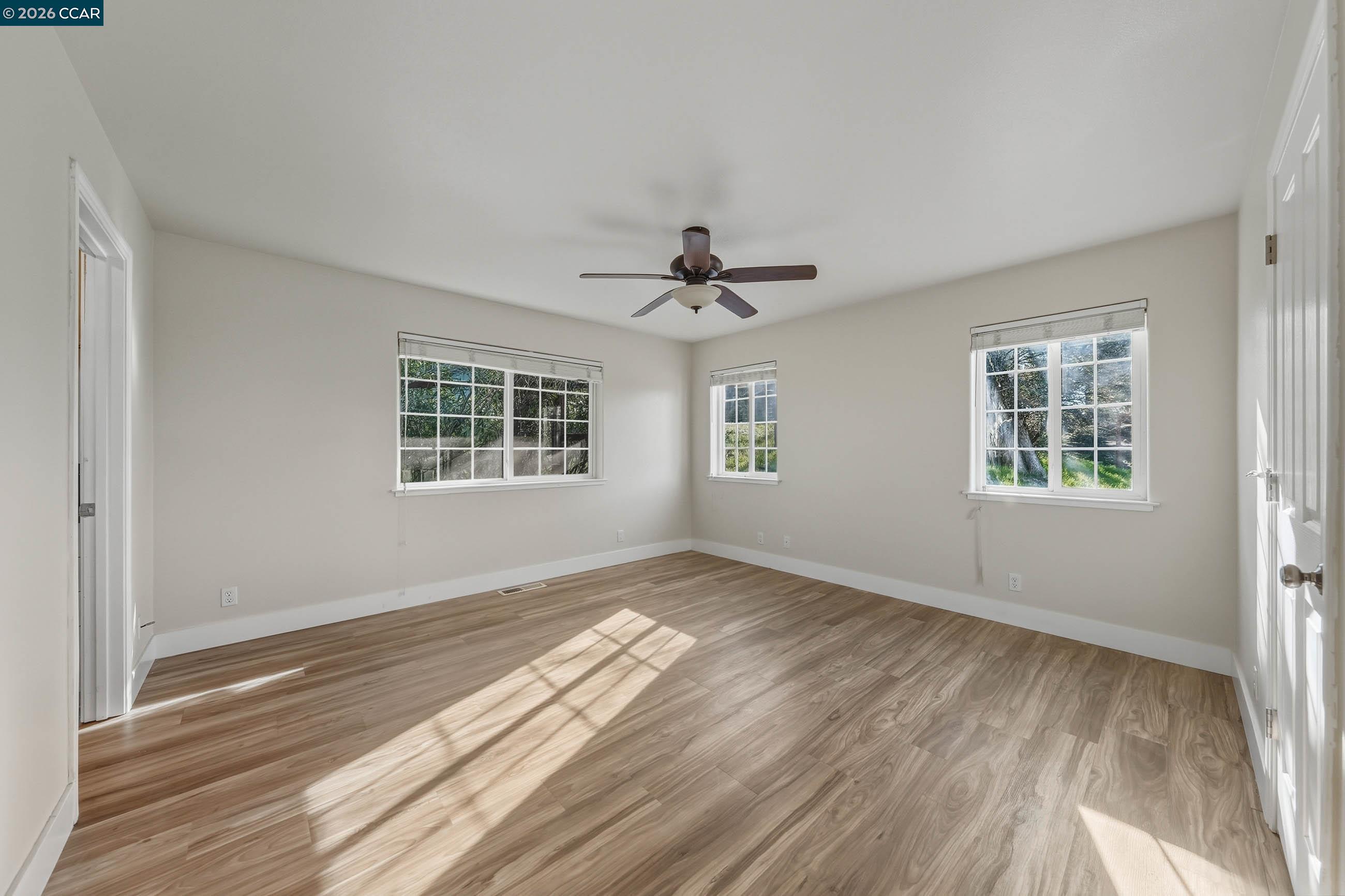 18357 Deer Hill Road Hidden Valley Lake, CA 95467 - Photo 20 of 29 a view of empty room with wooden floor and fan