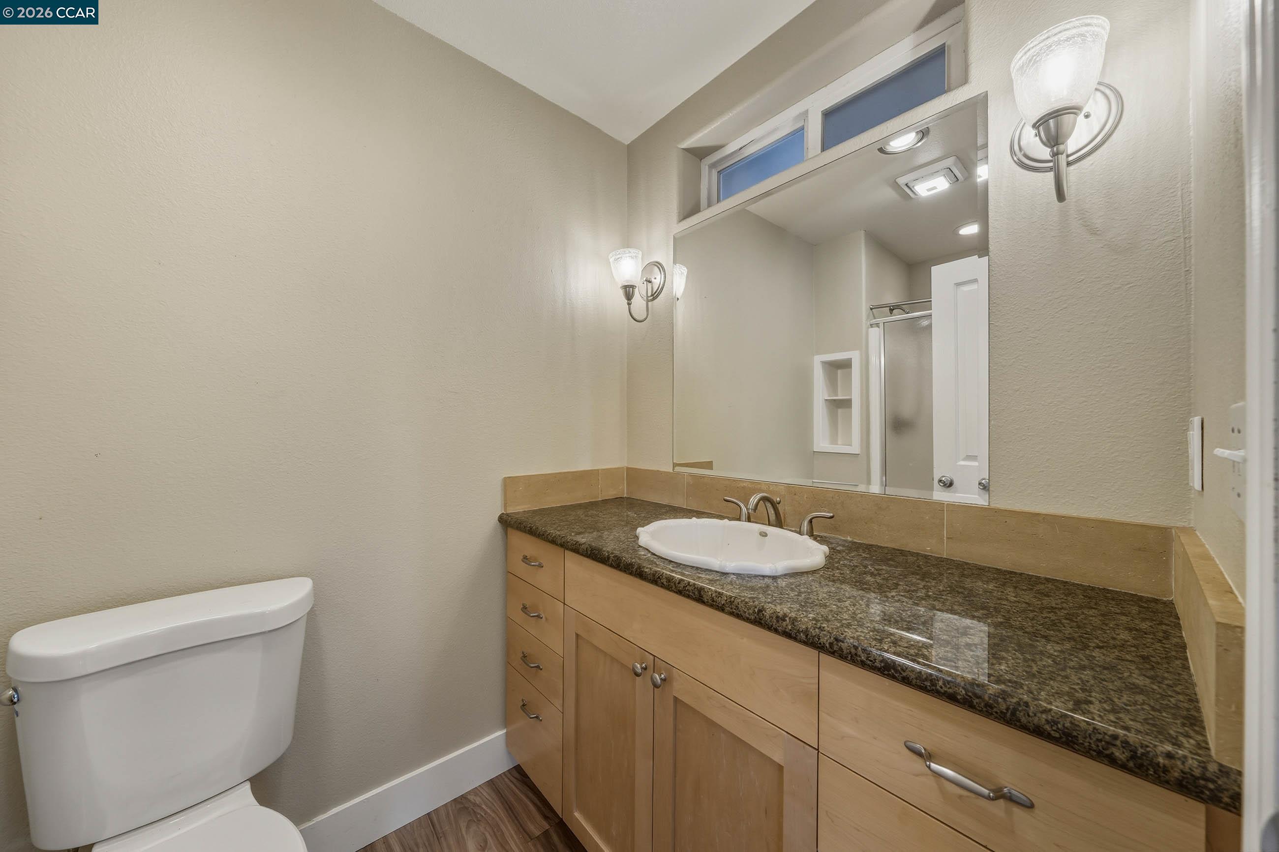 18357 Deer Hill Road Hidden Valley Lake, CA 95467 - Photo 21 of 29 a bathroom with a granite countertop sink and a mirror
