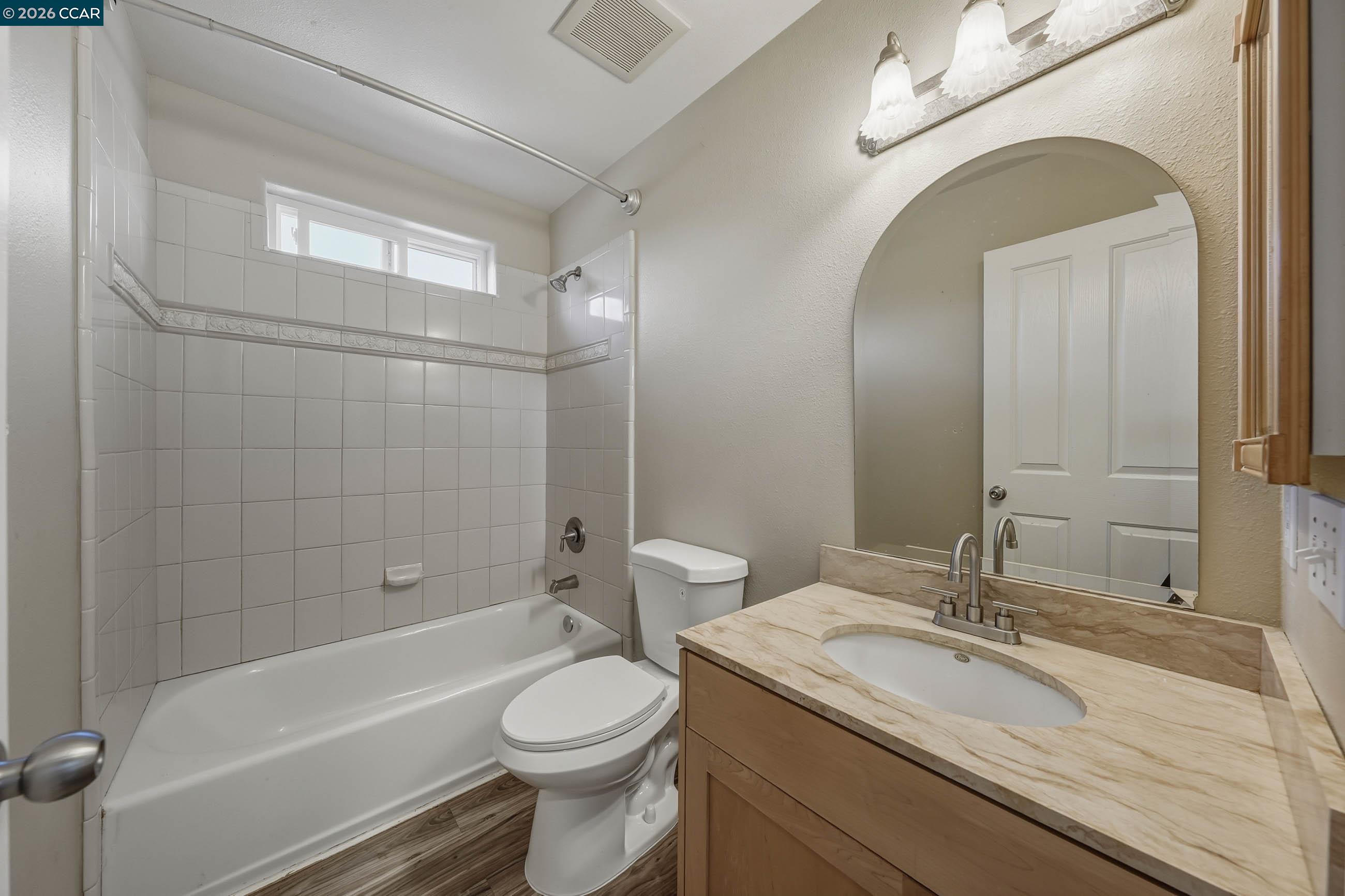18357 Deer Hill Road Hidden Valley Lake, CA 95467 - Photo 25 of 29 a bathroom with a granite countertop sink a toilet and shower