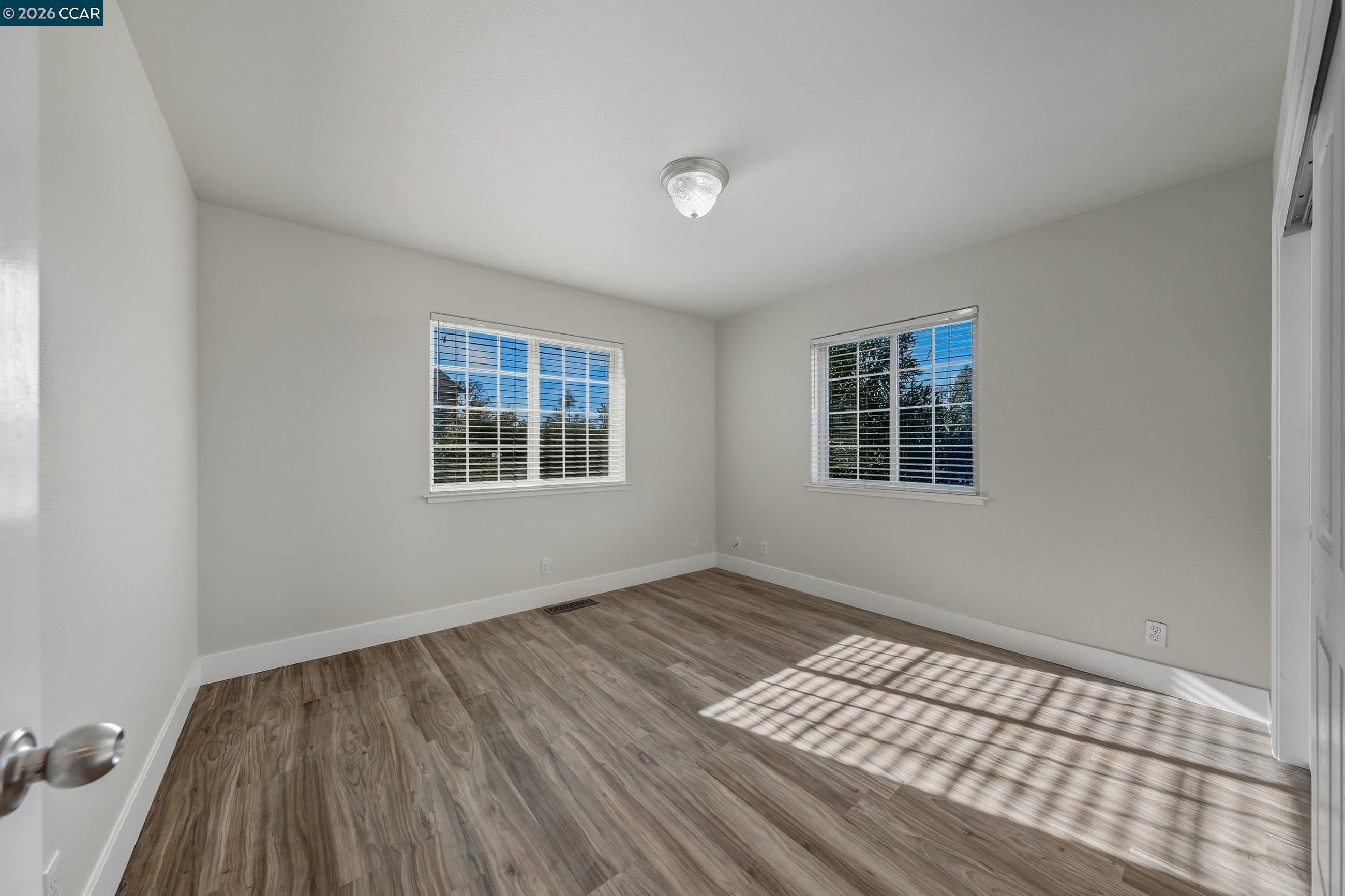 18357 Deer Hill Road Hidden Valley Lake, CA 95467 - Photo 26 of 29 a view of an empty room with wooden floor and a window