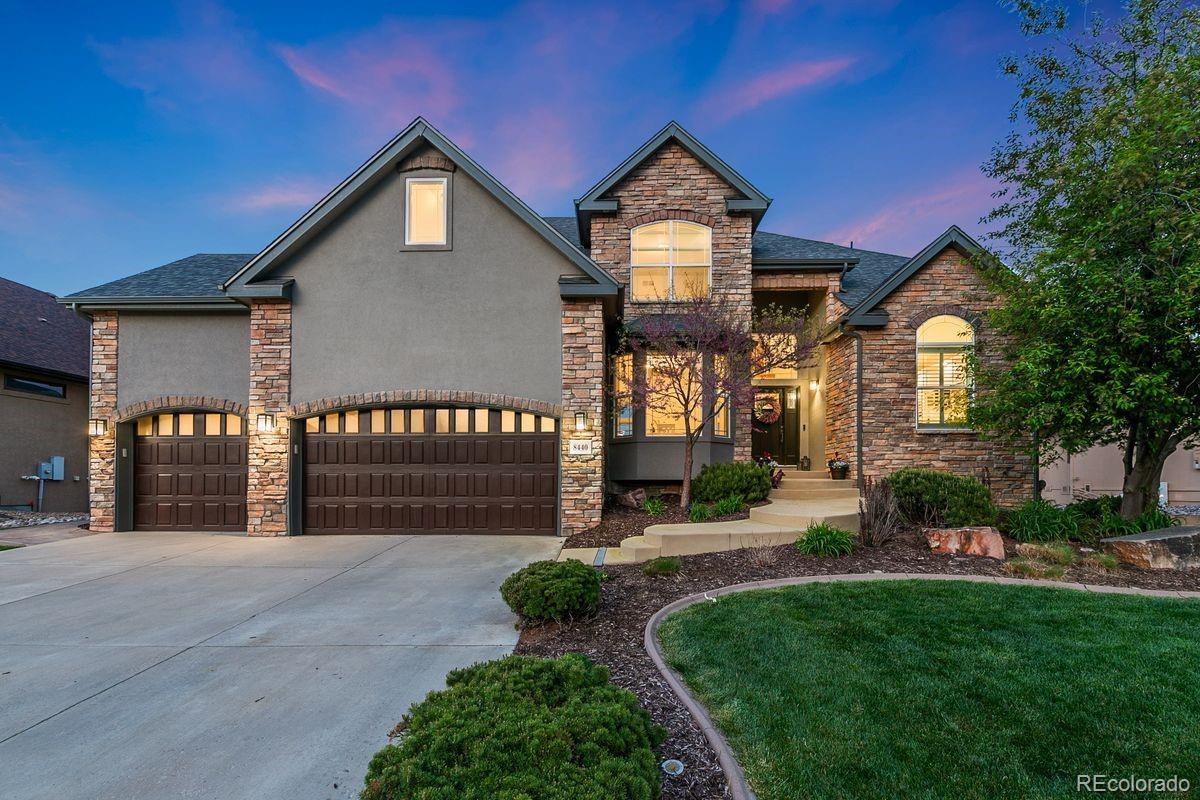 a front view of a house with a yard and potted plants