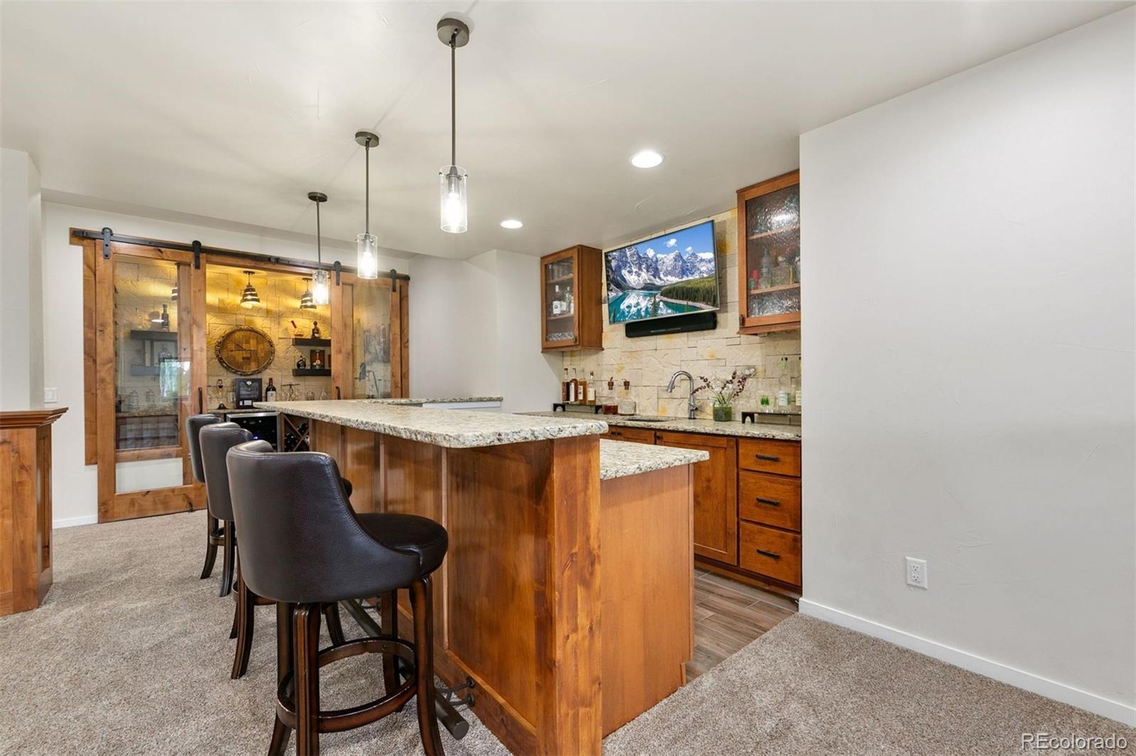 8440 Spinnaker Bay Drive Windsor, CO 80528 - Photo 26 of 36 a kitchen with stainless steel appliances granite countertop a sink a stove a refrigerator a dining table and chairs with wooden floor
