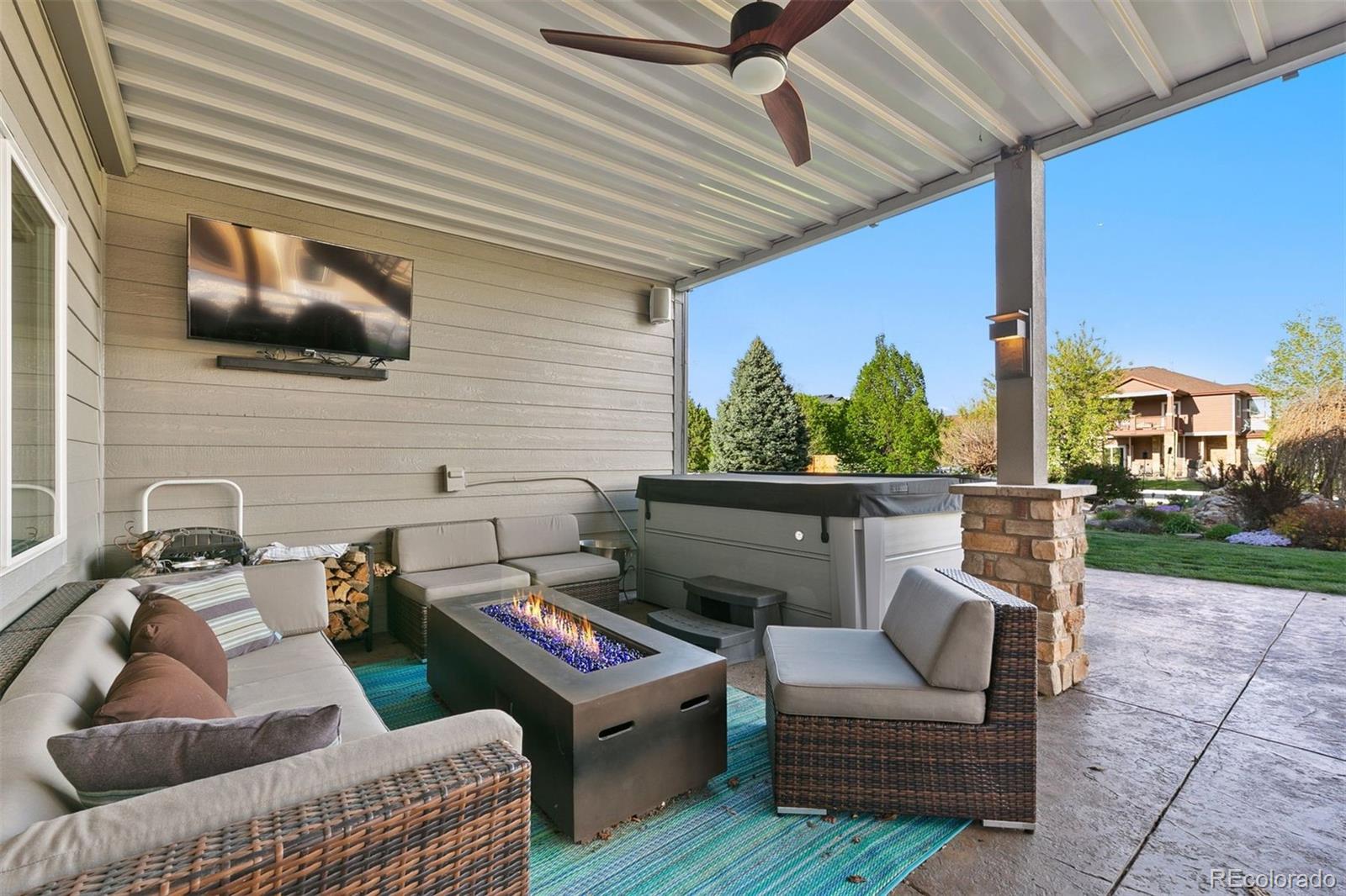 8440 Spinnaker Bay Drive Windsor, CO 80528 - Photo 30 of 36 a outdoor living space with furniture and a flat screen tv