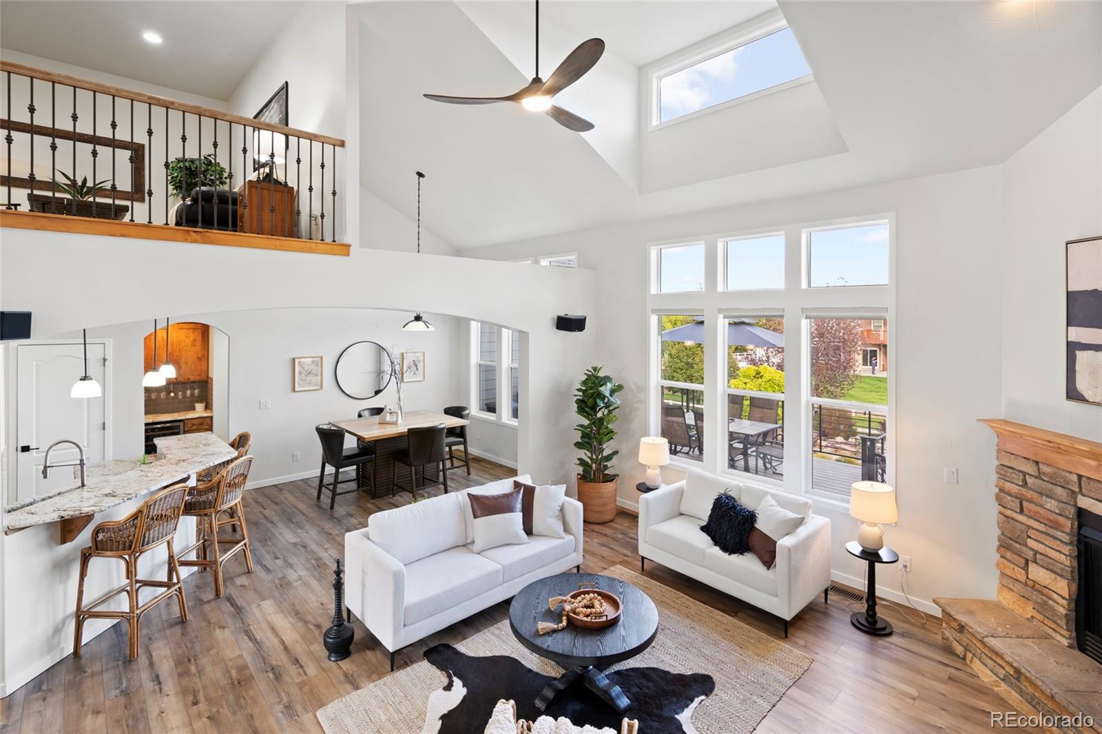 8440 Spinnaker Bay Drive Windsor, CO 80528 - Photo 3 of 36 a living room with furniture and a large window
