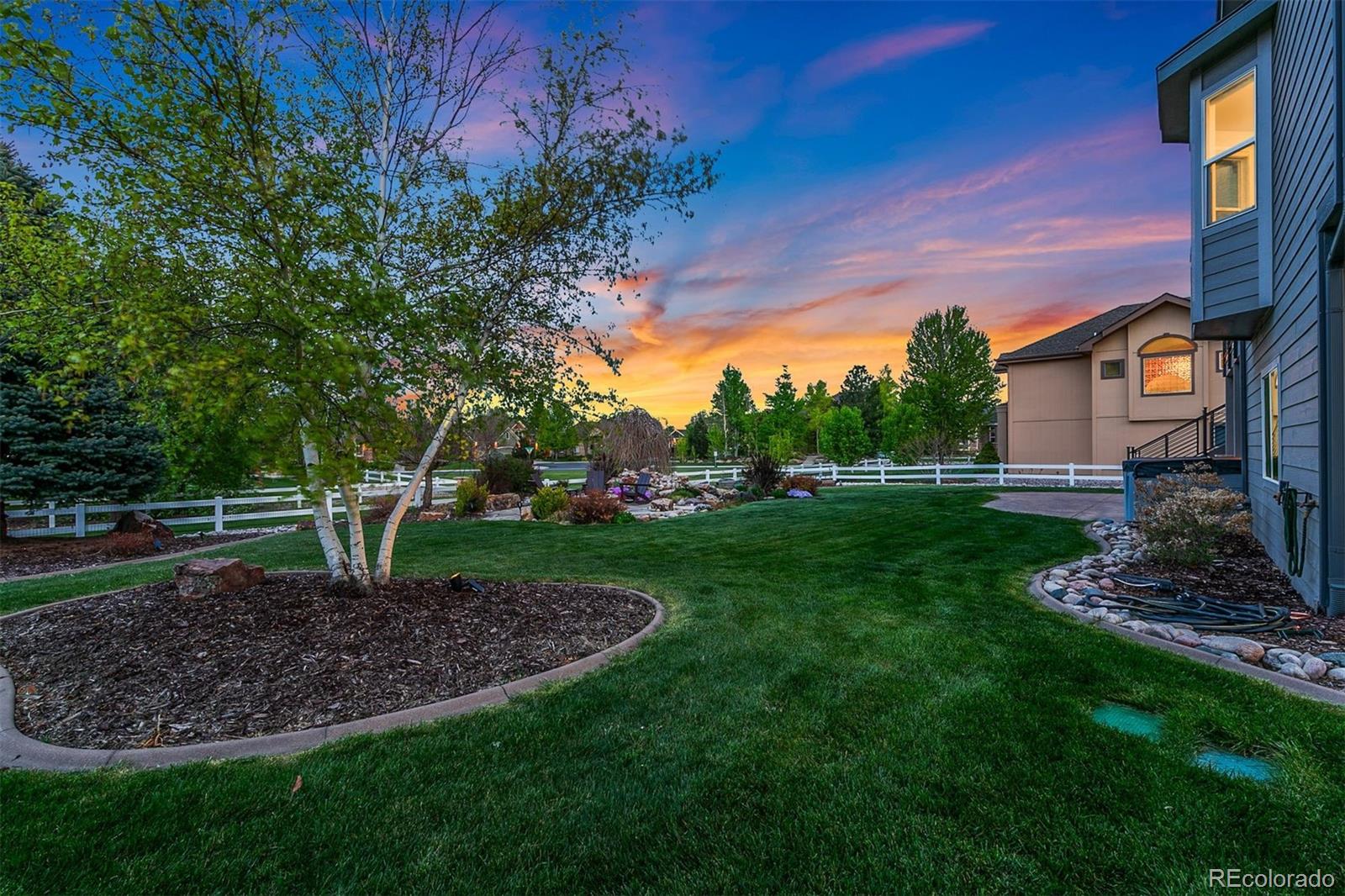 8440 Spinnaker Bay Drive Windsor, CO 80528 - Photo 31 of 36 a view of a backyard with plants and a tree