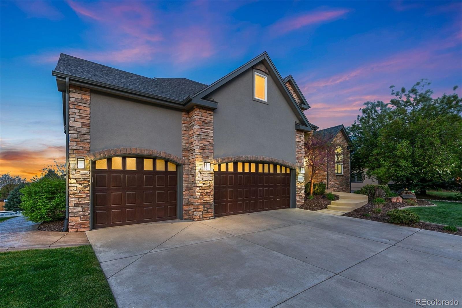 8440 Spinnaker Bay Drive Windsor, CO 80528 - Photo 32 of 36 a front view of a house with a yard and garage