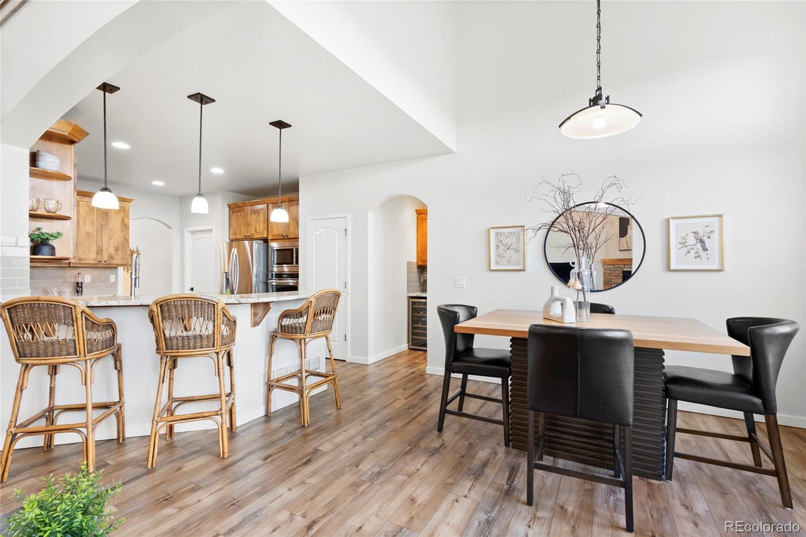8440 Spinnaker Bay Drive Windsor, CO 80528 - Photo 4 of 36 a view of a dining room with furniture window and wooden floor