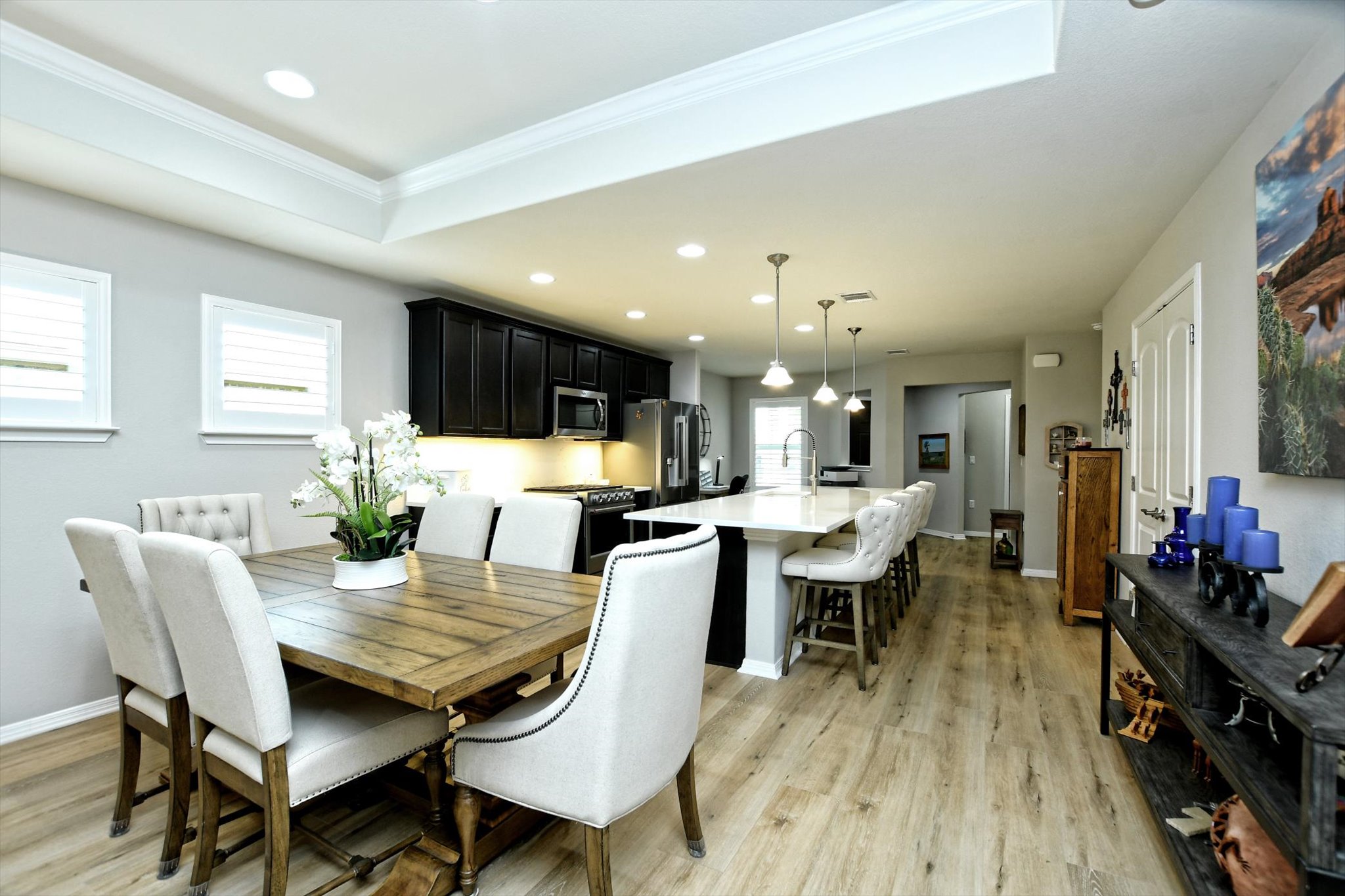 231 Hobby Street Georgetown, TX 78633 - Photo 8 of 29 An open-concept design connects a well-appointed kitchen with an elegant dining area, perfect for gatherings.