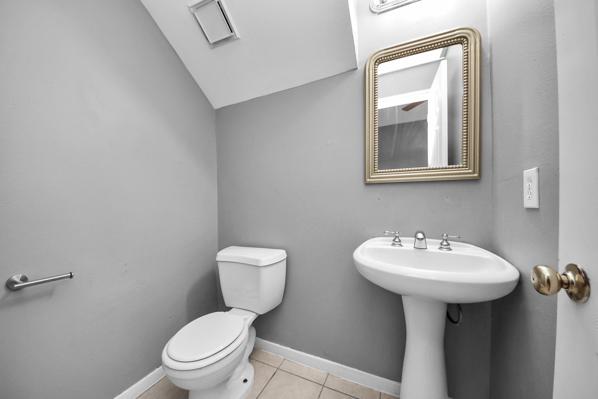 8126 Jutland Road Houston, TX 77033 - Photo 17 of 46 a bathroom with a toilet sink and mirror