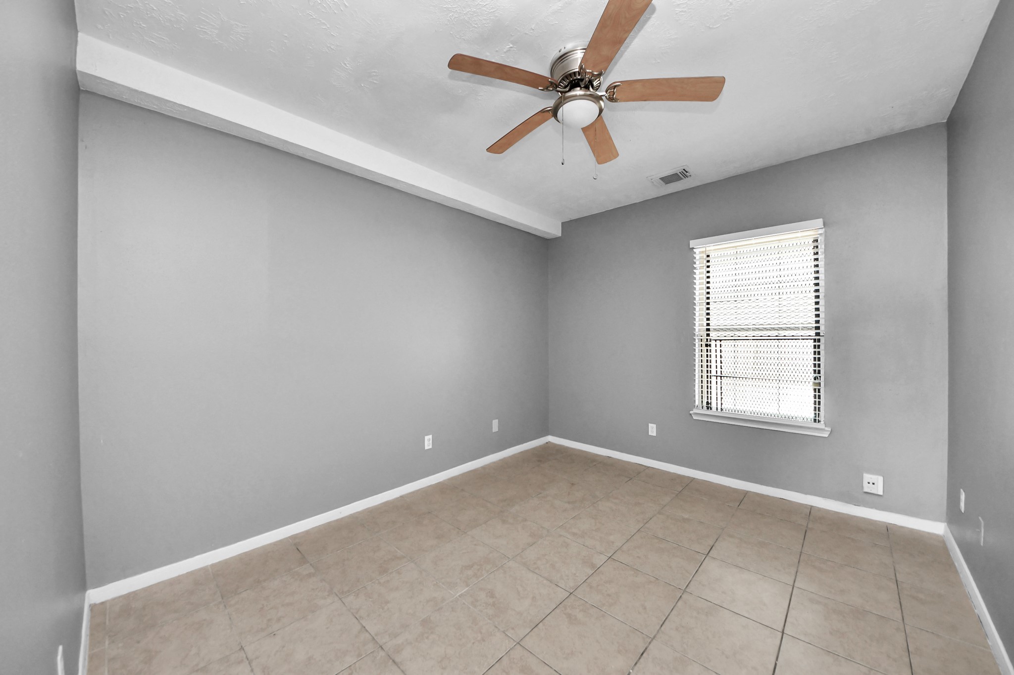 8126 Jutland Road Houston, TX 77033 - Photo 24 of 46 an empty room with a window and a fan