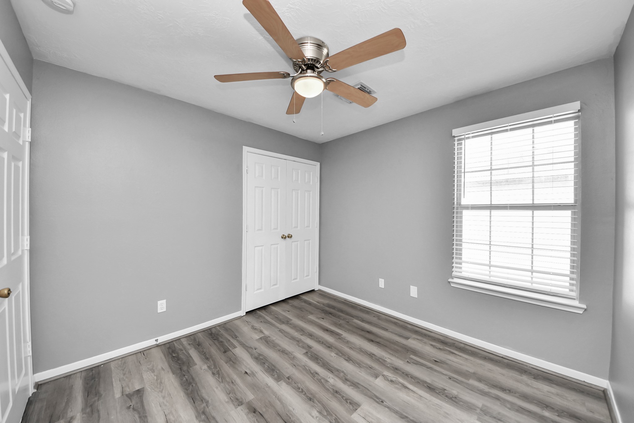8126 Jutland Road Houston, TX 77033 - Photo 35 of 46 wooden floor in an empty room with a window