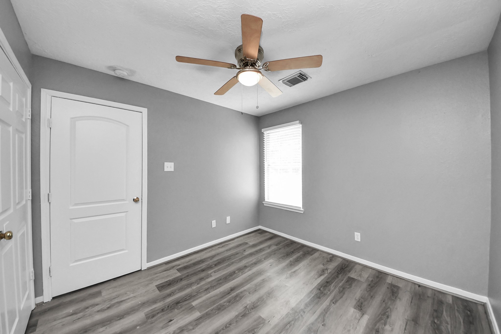 8126 Jutland Road Houston, TX 77033 - Photo 37 of 46 wooden floor in an empty room with a window