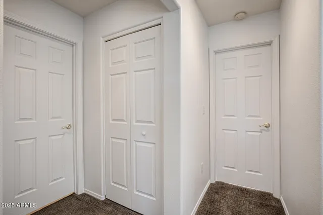 a view of a hallway with washer and dryer