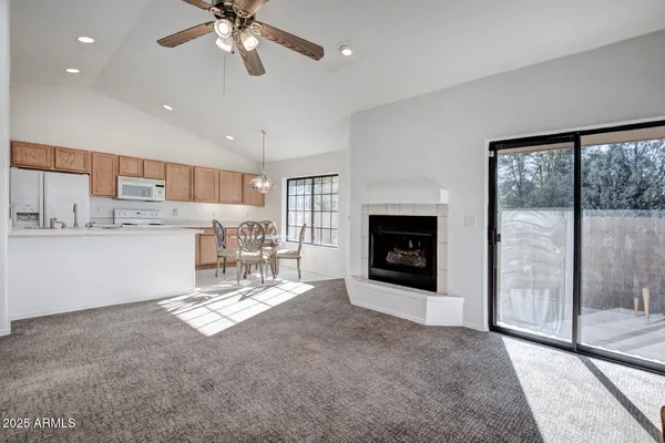a view of a kitchen with a sink a fireplace a window and a kitchen