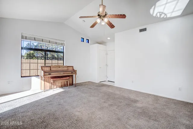 an empty room with furniture and windows