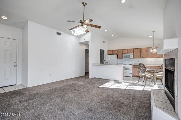 a view of a kitchen with a table and chairs