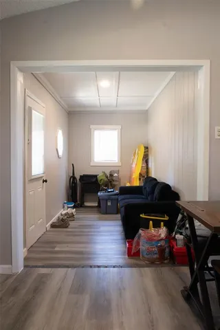 a living room with furniture gym equipment and a window