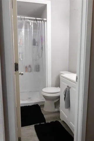 a bathroom with a toilet and a shower