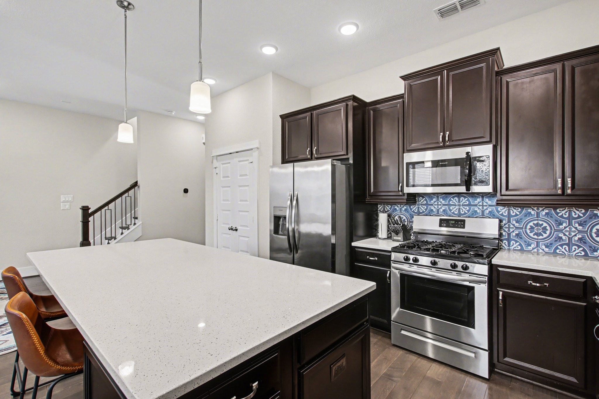 2007 Tarfite Place Houston, TX 77077 - Photo 9 of 24 a kitchen with kitchen island a stove a refrigerator a sink and chairs