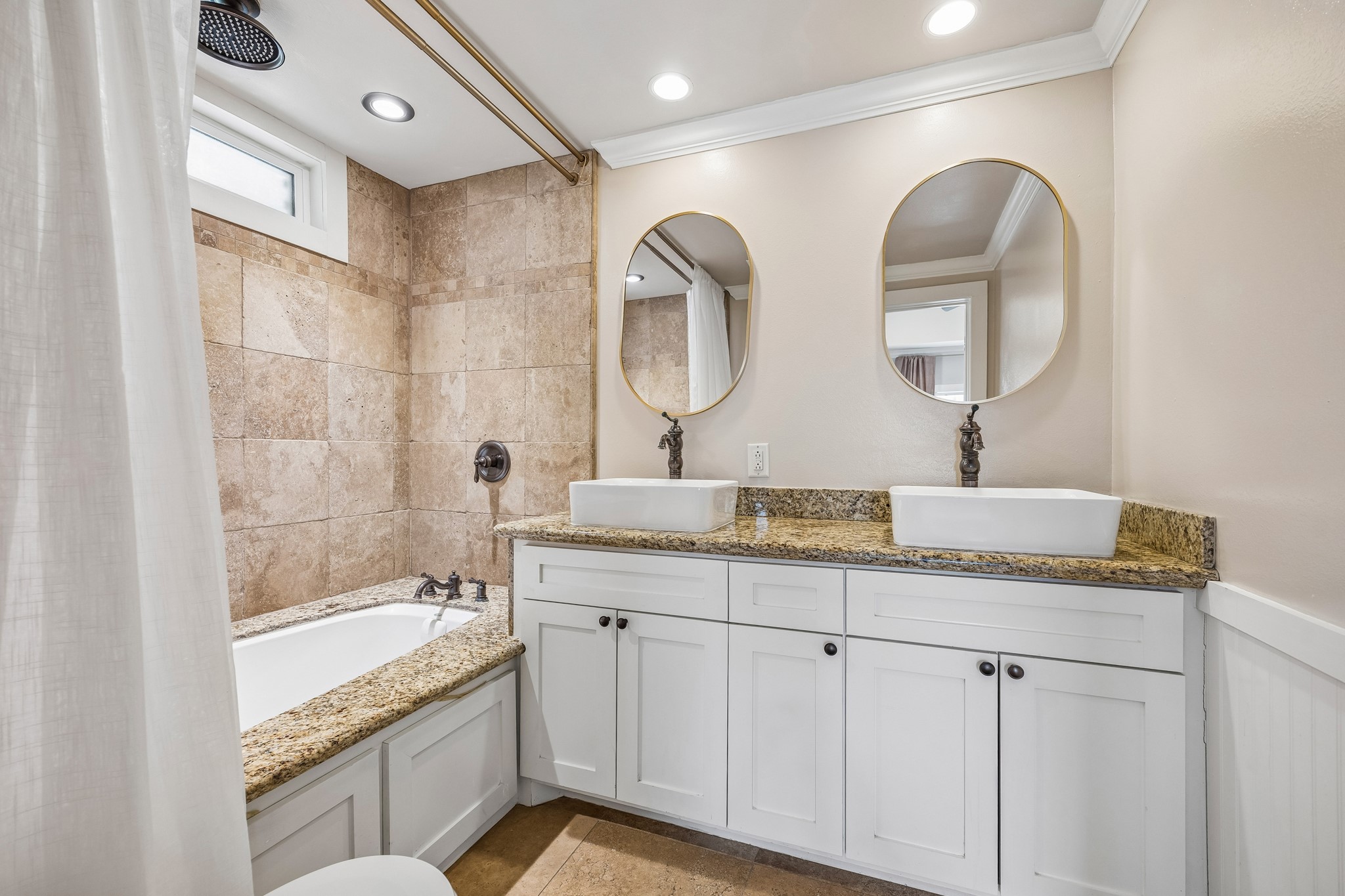 4412 Rusk Street Houston, TX 77023 - Photo 19 of 44 Luxurious spa-like tub/shower boasts granite & tile surround, exquisite millwork on base of tub, rain shower head & upgraded hardware.